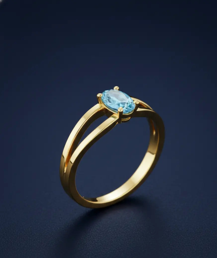 Detail of the 4-prong setting and transparent blue aquamarine on the 14K gold Clear Breath Ring.