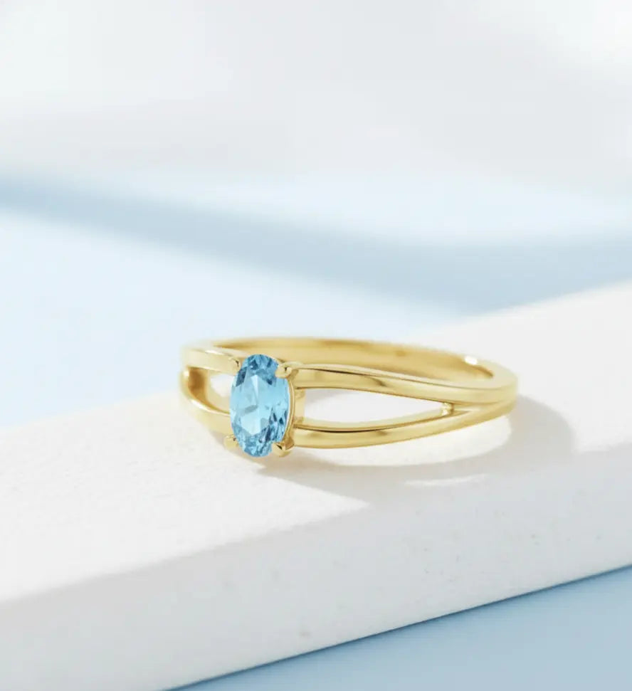 The Clear Breath Ring in handcrafted 14K gold featuring a natural oval-cut aquamarine gemstone.