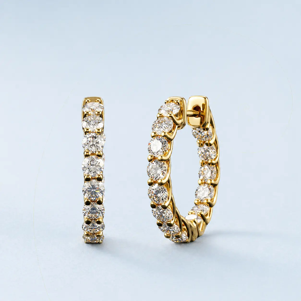 Minimalist 14K gold diamond hoop earrings worn for a luxury aesthetic.
