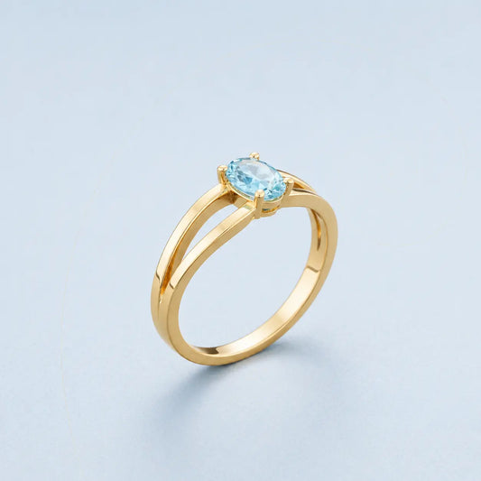 The Clear Breath Ring in handcrafted 14K gold featuring a natural oval-cut aquamarine gemstone.